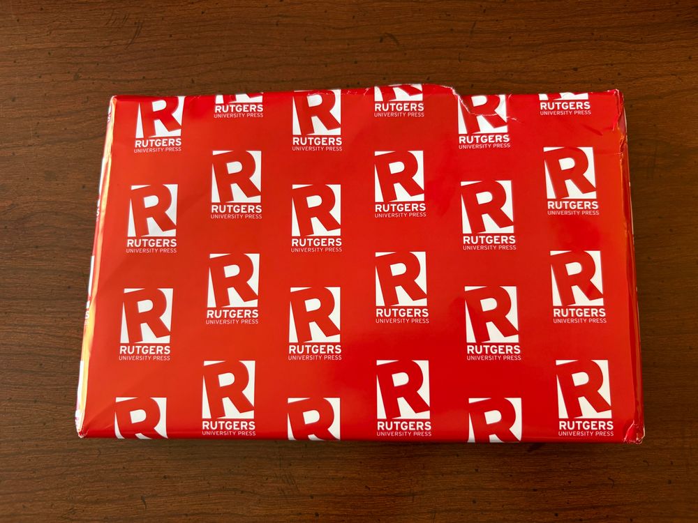 Book shape wrapped in Rutgers University Press paper 