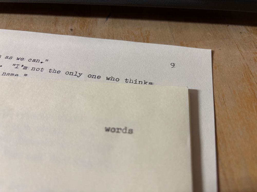 Sheaf of typewritten pages, briefly fanned so that one can see the top sheet (with “words” written in the upper right corner), and the bottom sheet, with the page number of 9 in the upper corner.
