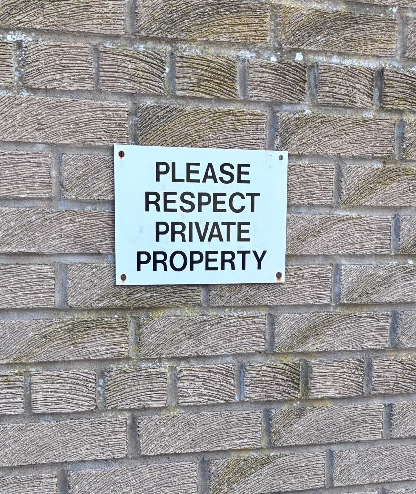 Sign on wall reading  PLEASE
RESPECI PRIVATE
PROPERTY