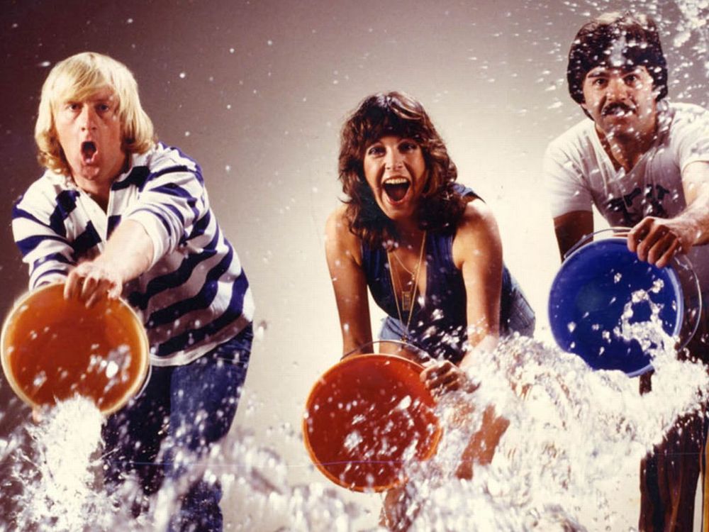 The presenters of Tiswas throwing buckets of water.