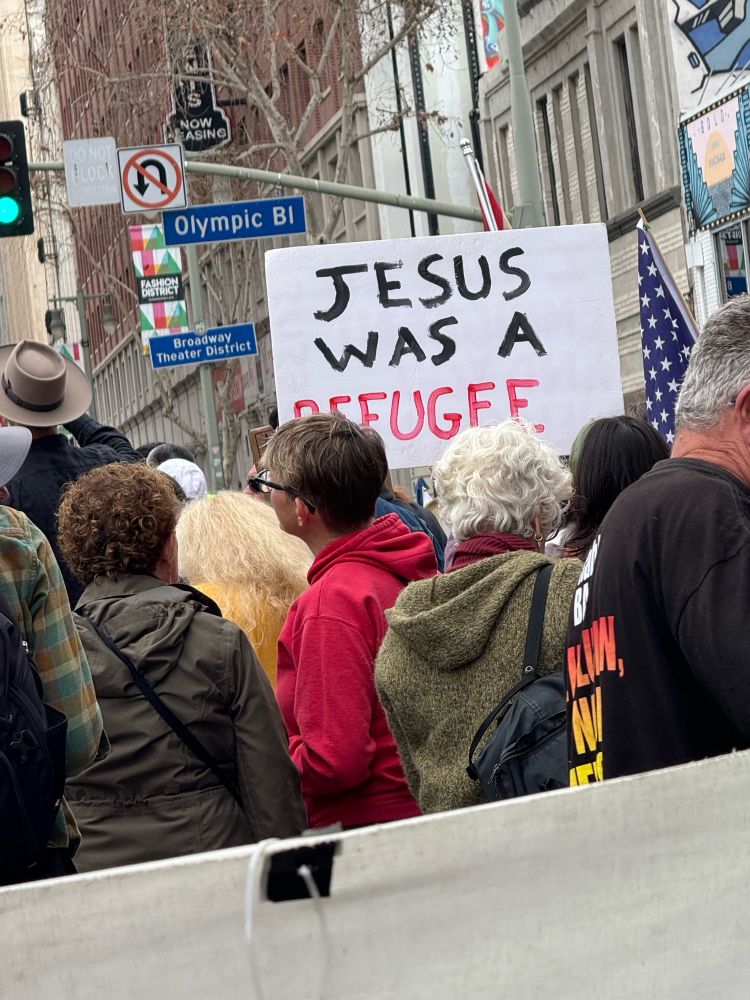 Sign at March says Jesus was a refugee.