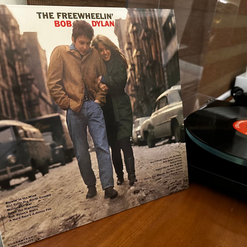 Cover of the Bob Dylan album “The Freewheelin’ Bob Dylan” featuring a photo of Bob Dylan walking arm-in-arm with Suze Rotolo down Jones Street in New York City.