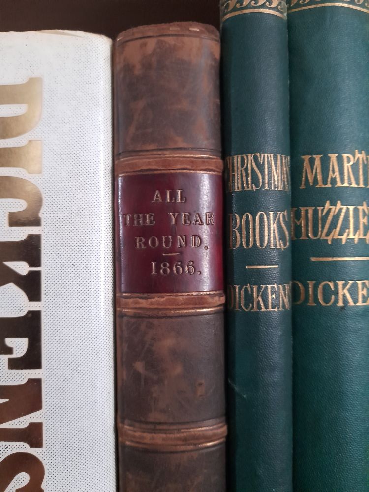 An old-fashioned brown book spine with the words 'ALL THE YEAR ROUND. 1866.' stamped against red.