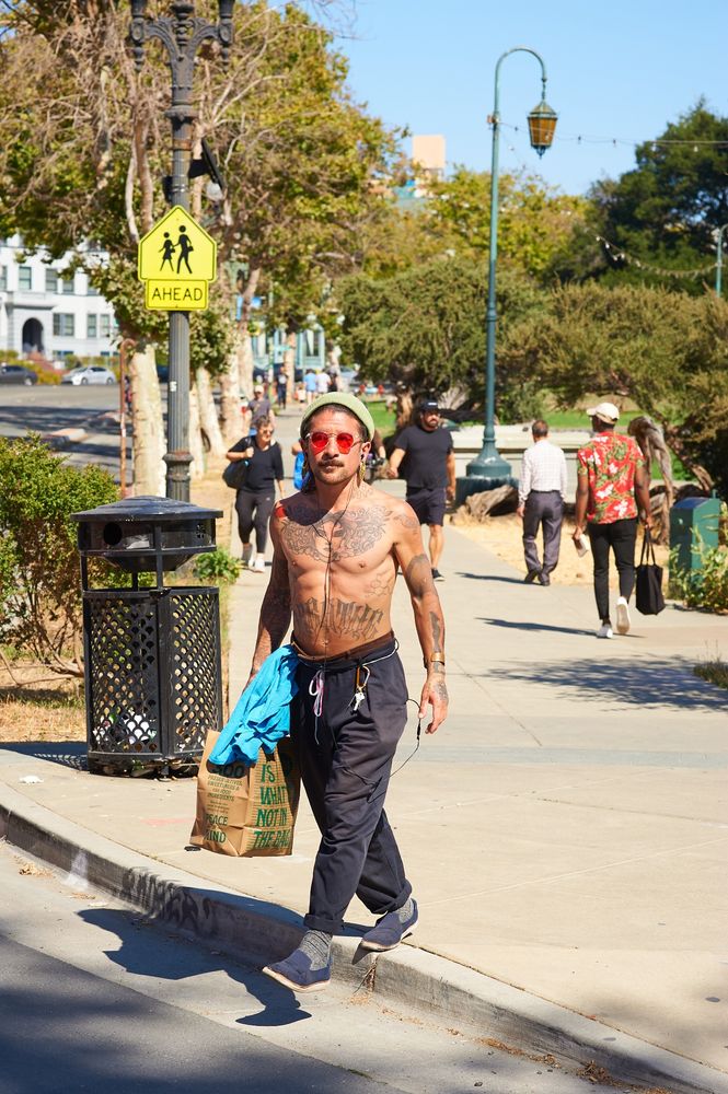 A man walking on Grand Ave near Lake Merritt