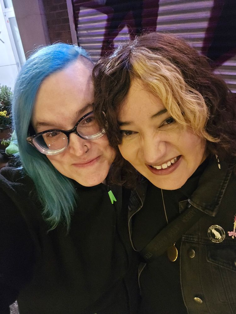 Blue-haired girl with a very hot girl whomst she loves