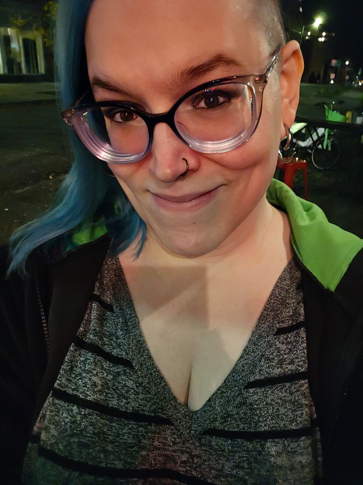 a fairly tipsy blue-haired girl outside on a street