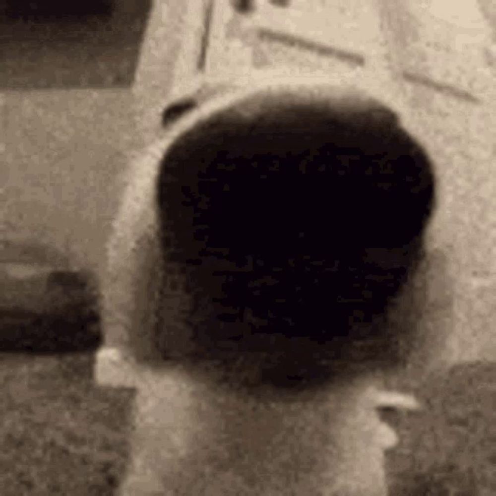 a black and white photo of a mailbox with a person standing in it .