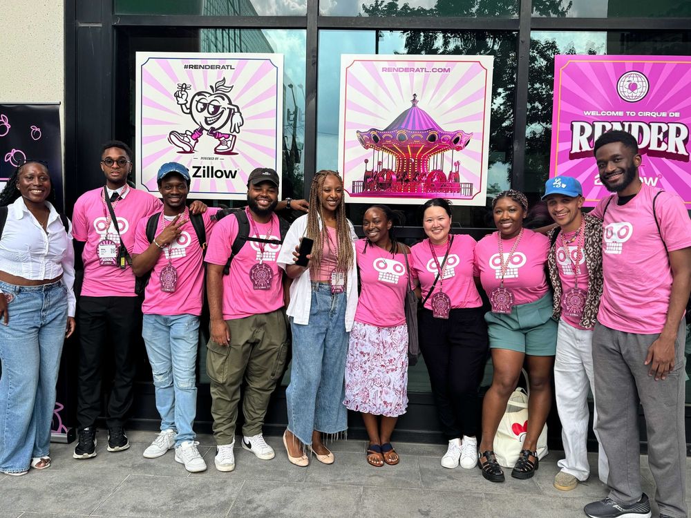 RC staff and alumni posing in front of RenderATL posters