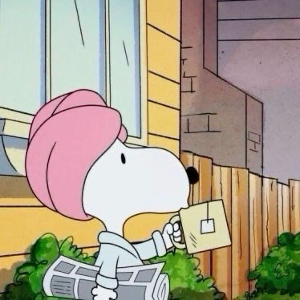 Snoopy with a pink towel wrapped around his head. He is also holding a newspaper and drinking a mug of tea.