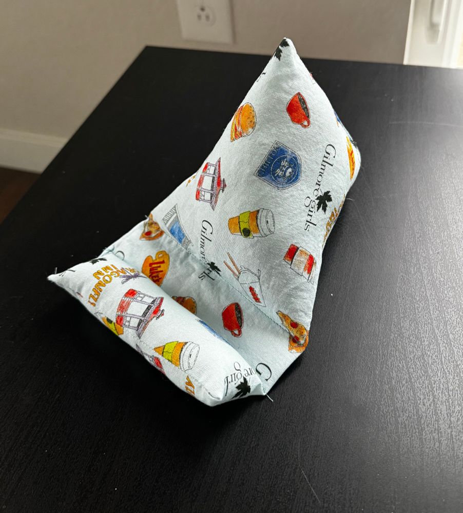 A pillow stand for a phone or ereader made with “Gilmore girls” fabric 