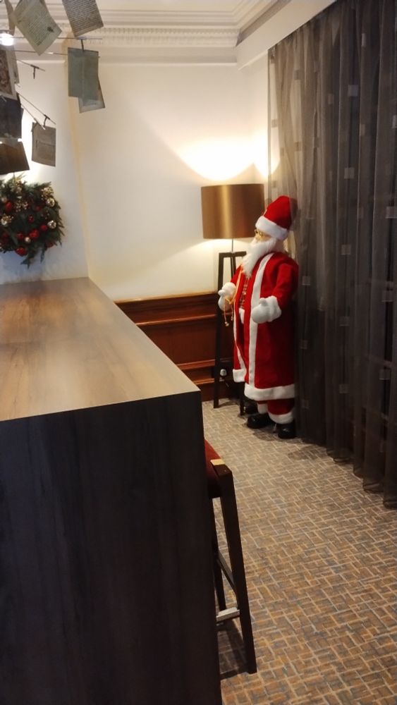 Hotel lobby. Figurine of father Christmas shoved in a corner 