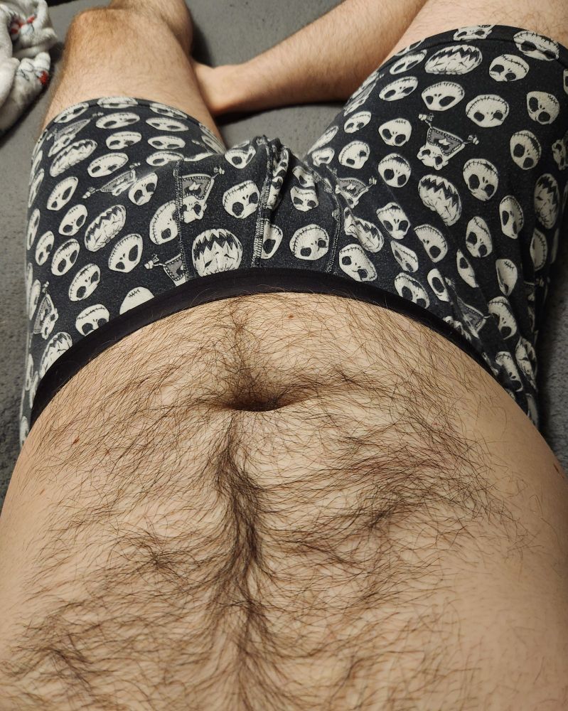 Laying in bed. Hairy belly. Im wearing jack skellington underwear.
