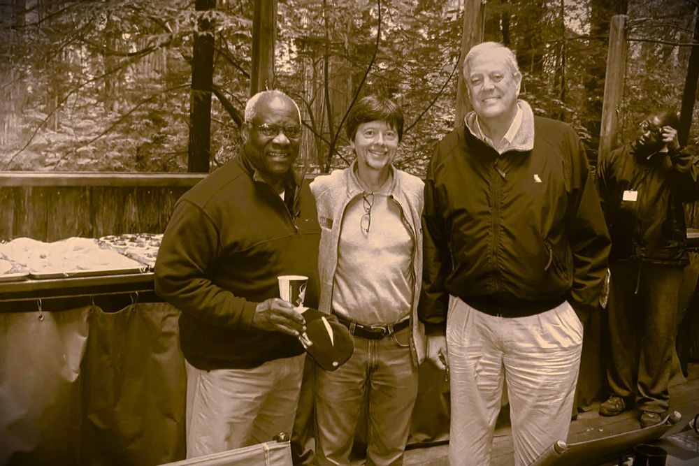 edited photo (made sepia-tone) from quoted propublica article of Ken burns flanked by Clarence Thomas and David Koch at Bohemian Grove