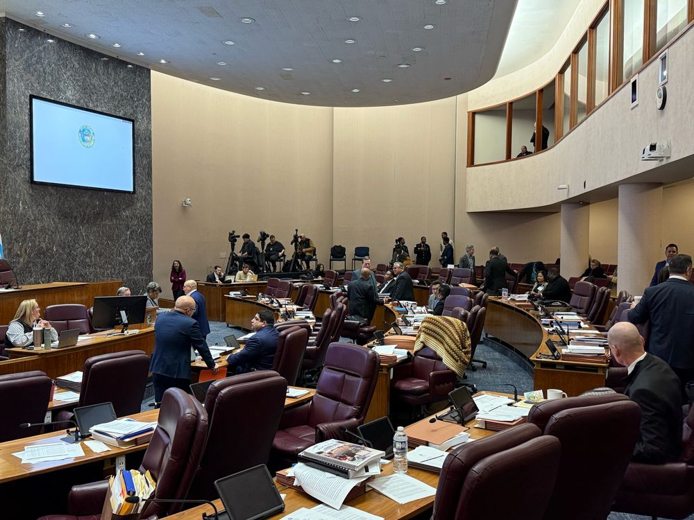 The Chicago city council chambers, curved rows of chairs facing a larger central desk.