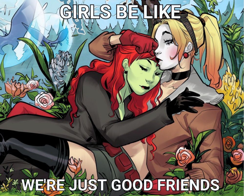 An excerpt from DC Comics Bombshells shows Harley Quinn and Poison Ivy laying down in a patch of mountainous forest, surrounded by flowers. They hug each other passionately, with Ivy putting her right hand on Harley's left shoulder and Harley putting her right hand on Ivy's head. Harley seems like she's about to kiss Ivy's forehead. A bit of white text superimposed on the image says "Girls be like "we're just good friends"".