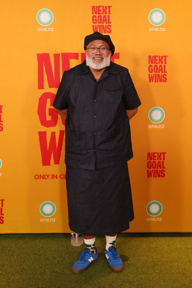 Dave Fane smiling in the photo line at the premiere for Next Goal Wins. 