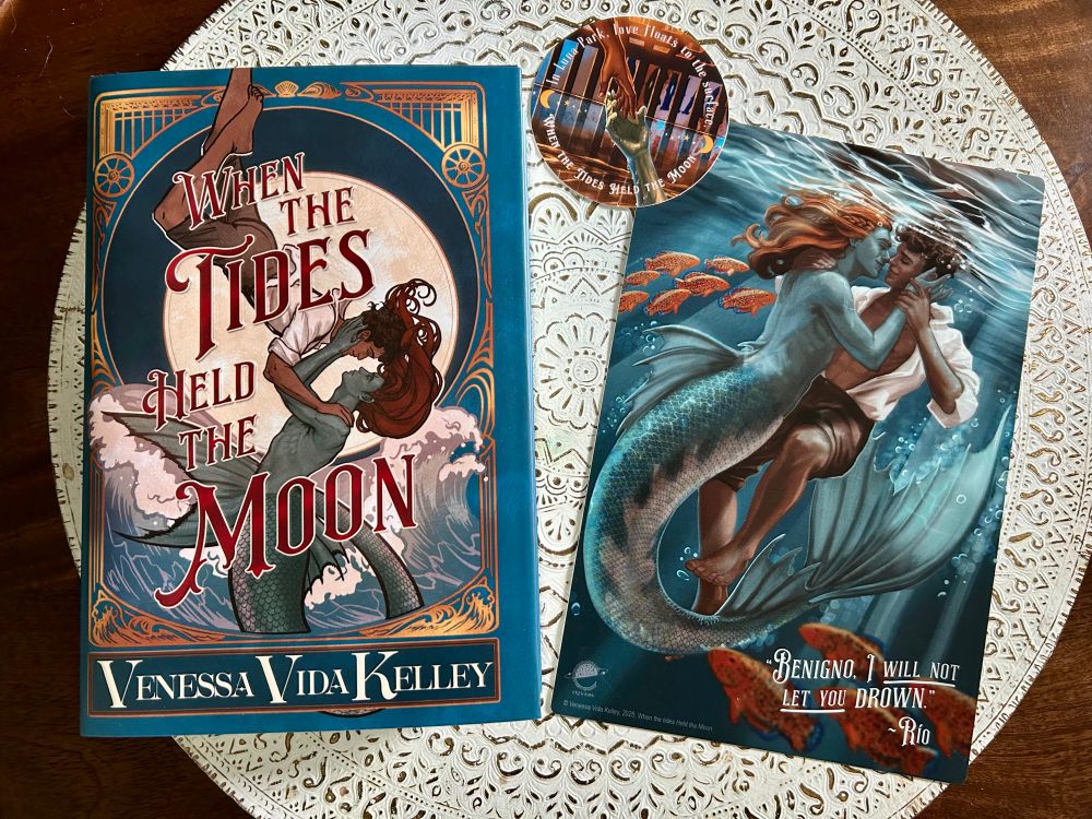 Image of When the Tides Held the Moon book along with an art print of the main characters and a sticker