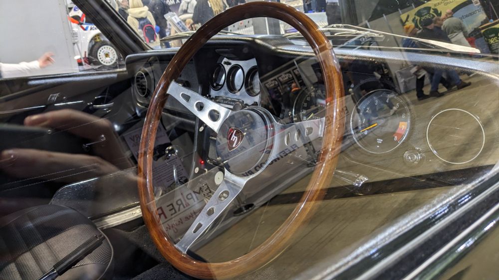 The classic steering wheel and some other bits of the interior, photographed through the side window.