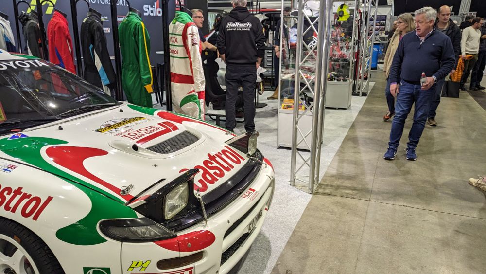 Nicky Grist (right) in the process of promoting his rally gear business. A Toyota Celica GT-Four WRC (ST185) looks on.