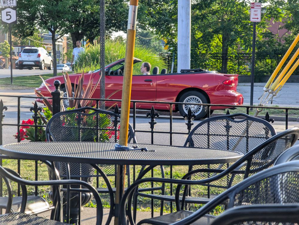 A red Chevrolet Cavalier convertible. 