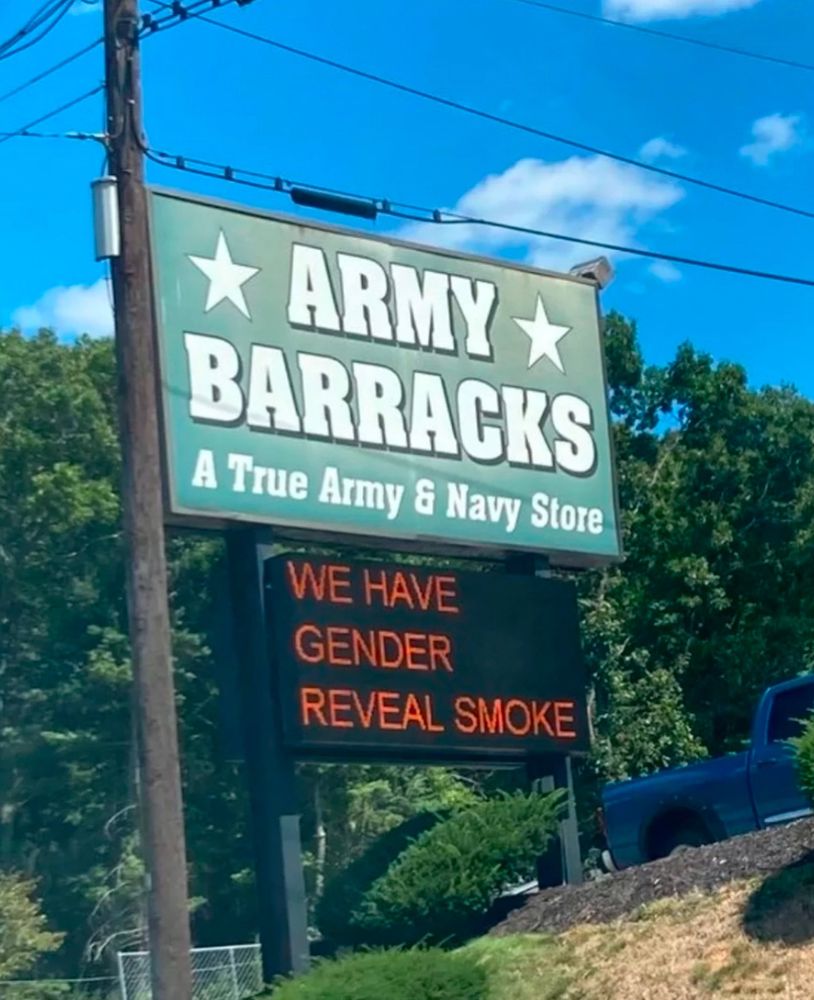 Image from Online of a sign reading “Army Barracks” and below that on a digital display:
WE HAVE
GENDER
REVEAL SMOKE