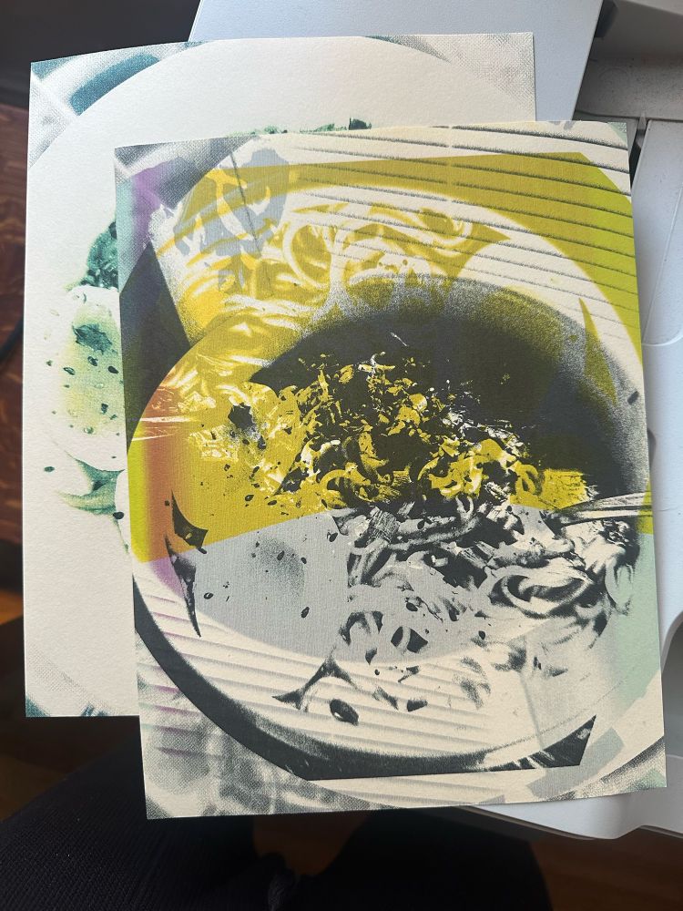 A photo of two printed images of the bowl of ramen