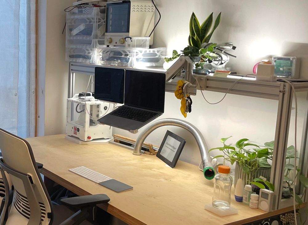 the desk (workbench) is pretty large, with an alu extrusion frame on top for lighting, as well as some plants. A laptop and ipad are mounted on a monitor arm.