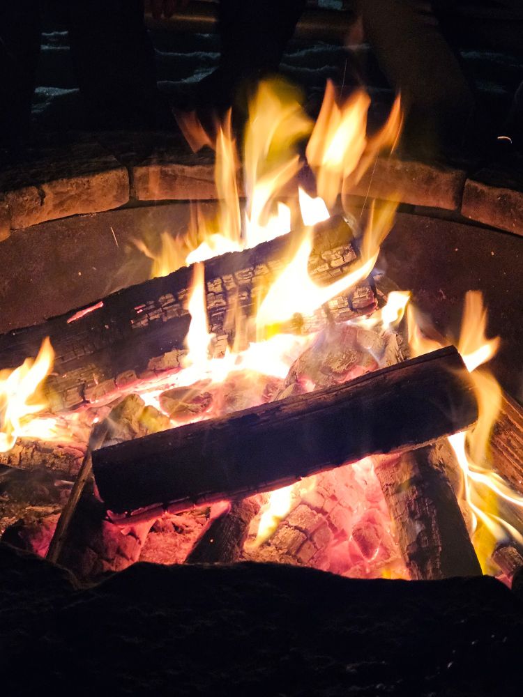 An image of a lit fire in a fire pit.