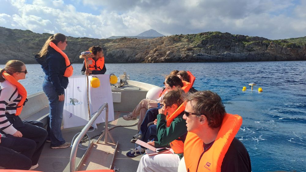 Students in the boat deploying the drifters. One drifter is floating in the right of the image.