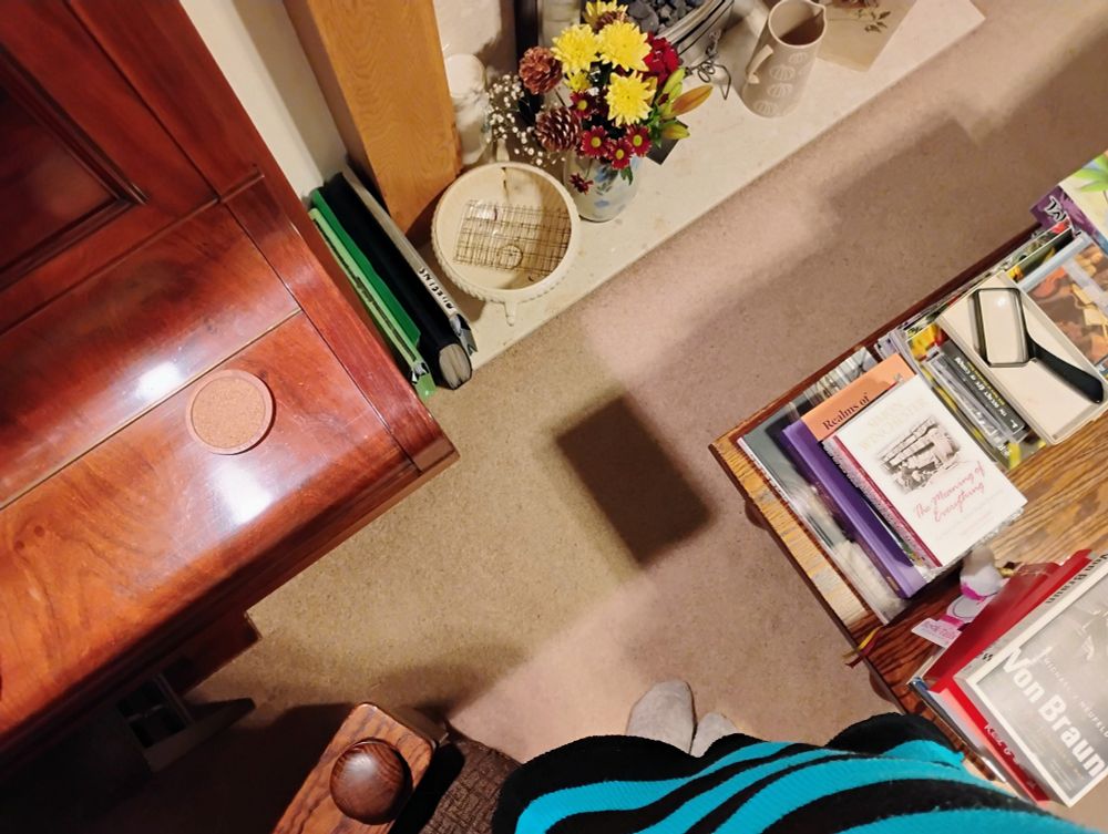 The same patch of shadow from a different angle, revealing that it is the overlap of two shadows, of two different objects from two different light sources 