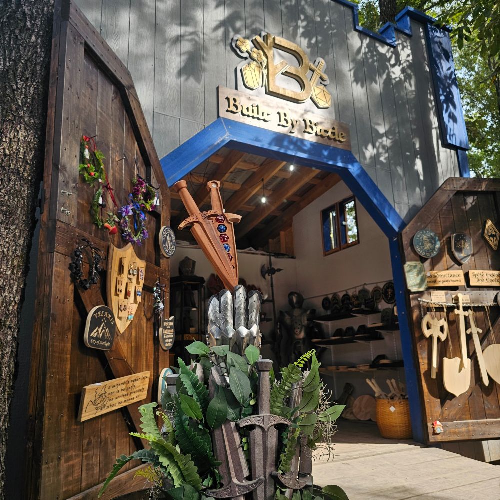 A picture of a blue and grey castle building selling wooden items and flowe crowns. 
