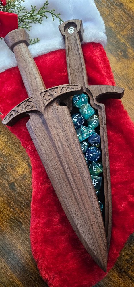 A wooden box shaped like a dagger with dice inside. 