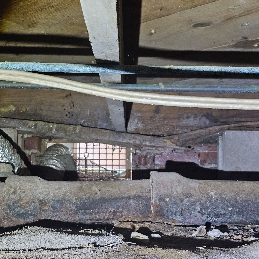 Damaged floor joists under a house. 