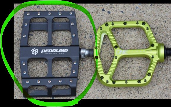A catalyst pedal next to a normal mtb flatpedal. It is a bit narrower but much longer