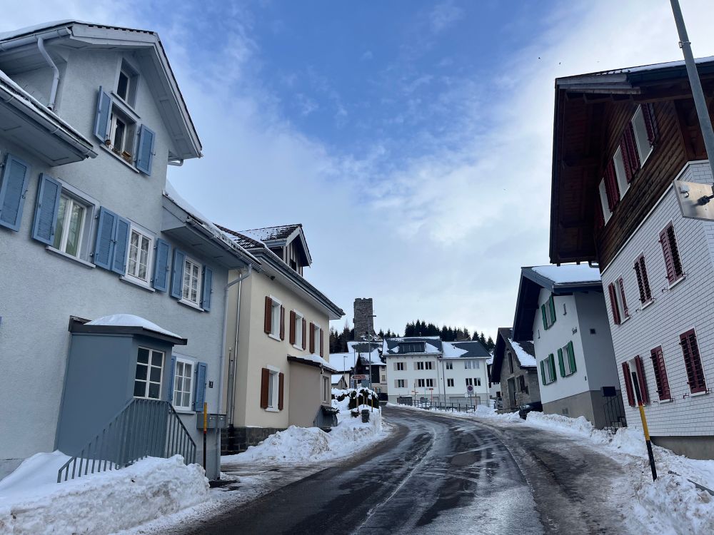 A snowy town with a particular castle tower in the back