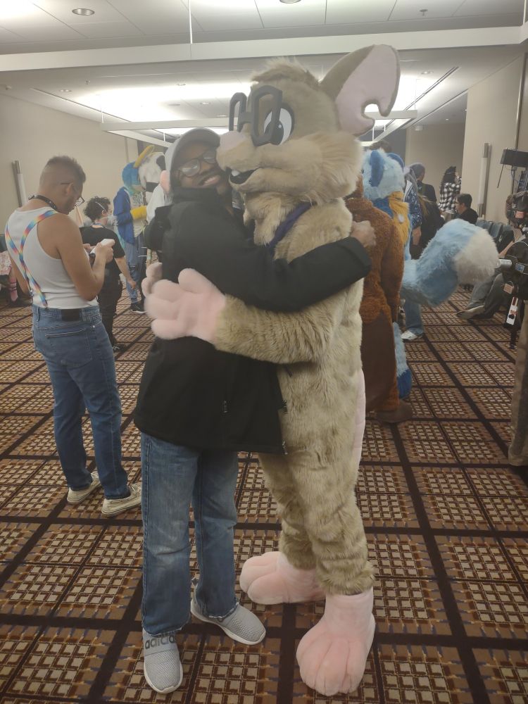 Codes getting hugged by Kilorat at the MFF Rodent meetup panel
