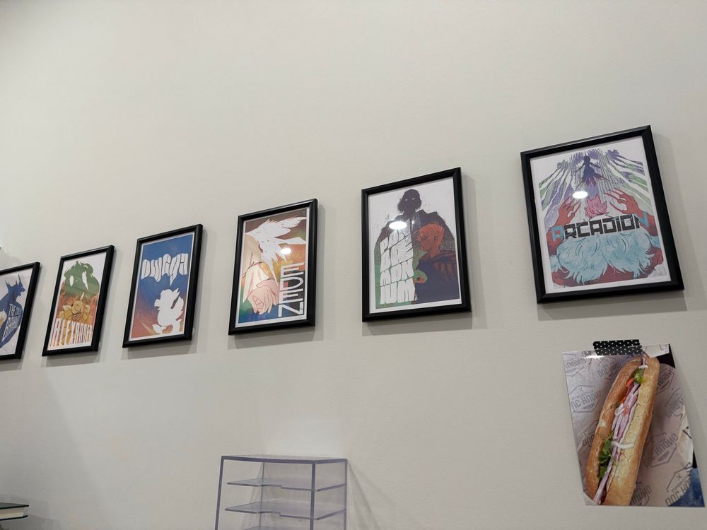 6 raid prints available at the link in the quoted tweet framed and hung in a row on a wall; a photograph of banh mi held up by washi tape also