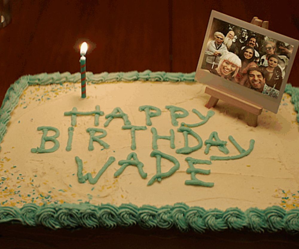 a birthday cake with the words happy birthday wade written in green letters