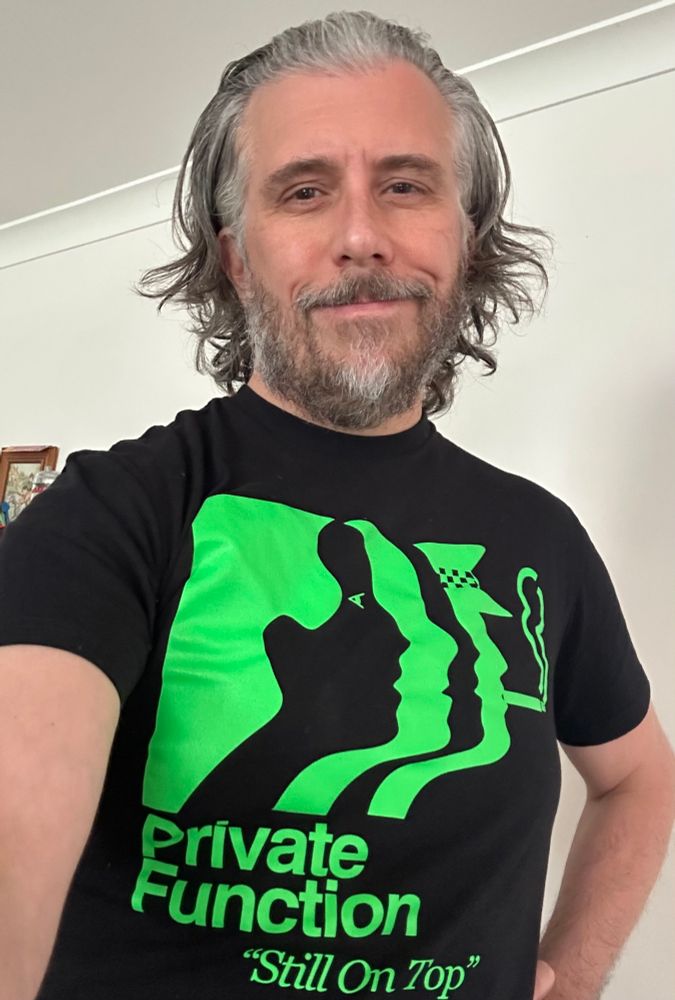 selfie of the author in a black and green Private Function shirt