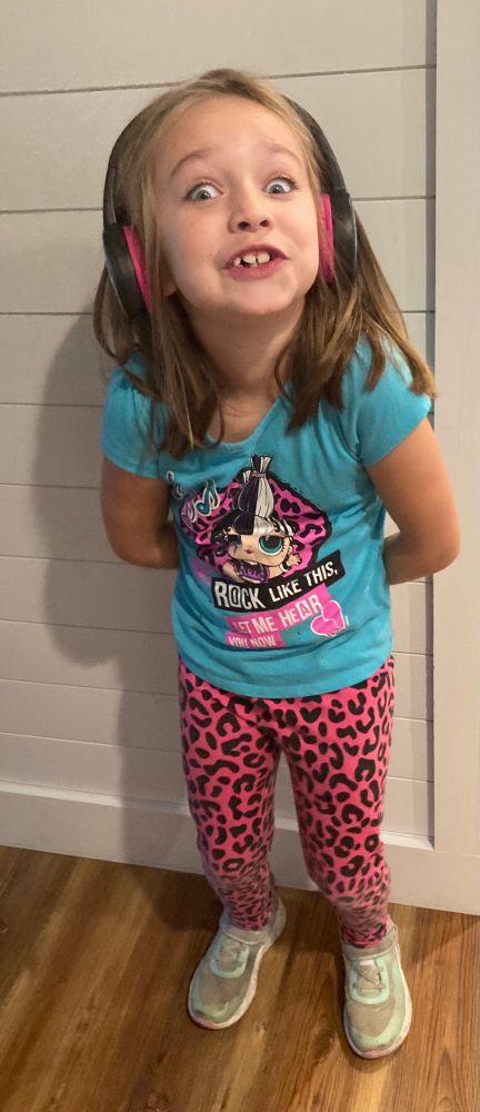My 7yo daughter wearing an L.O.L. Doll outfit and headphones