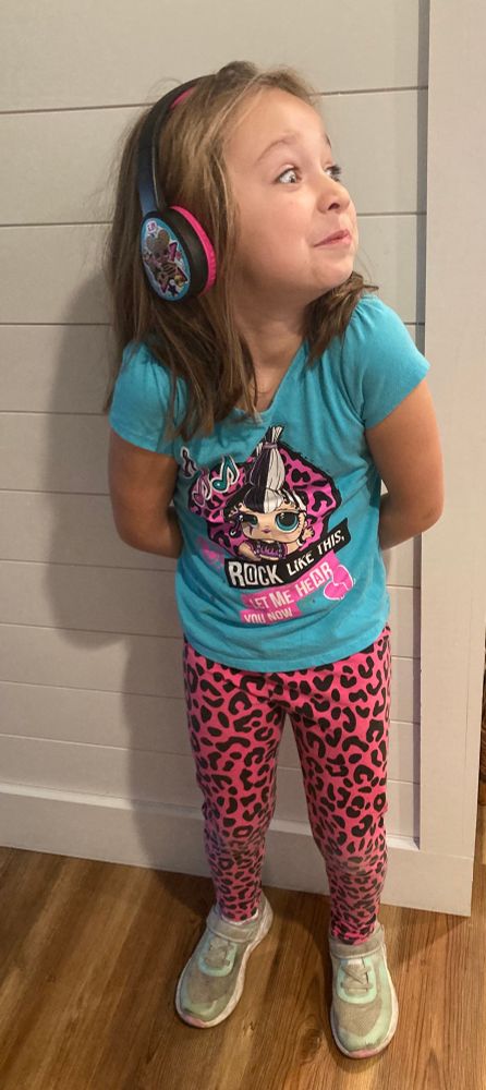 My 7yo daughter wearing an L.O.L. Doll outfit and headphones