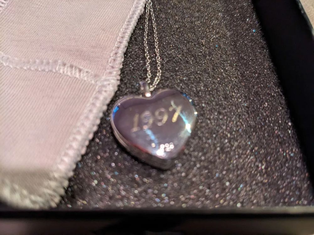 The back of the locket, engraved with "1997"