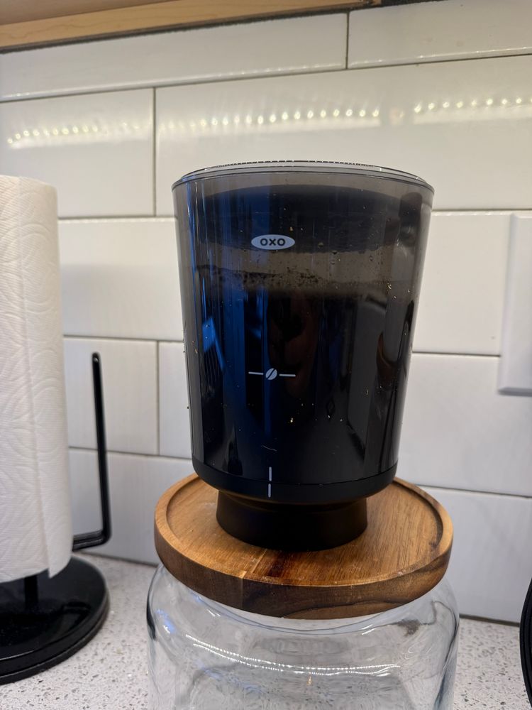 A container holding submerged beans for cold brew.