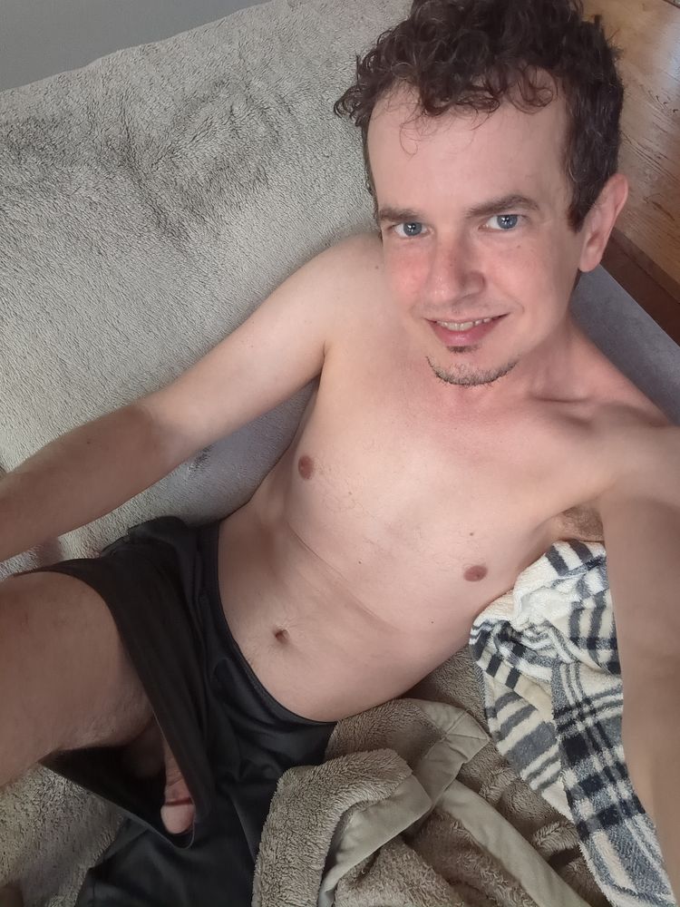In this photo, my dick has begun to grow half way to being hard and the big mushroom head can be seen pressing against the side of my shorts.