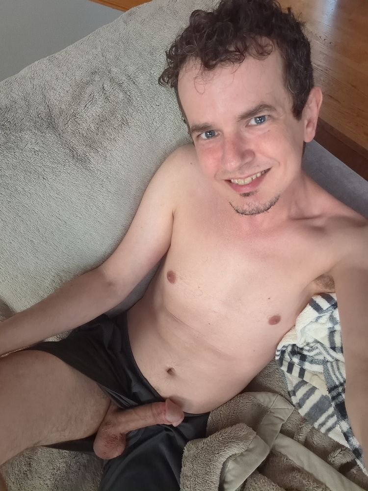 In this final selfie, I am smiling big at the camera while my fully hard fat cock has escaped from the leg of my gym shorts and is resting against my lower abdomen in clear view of the camera.