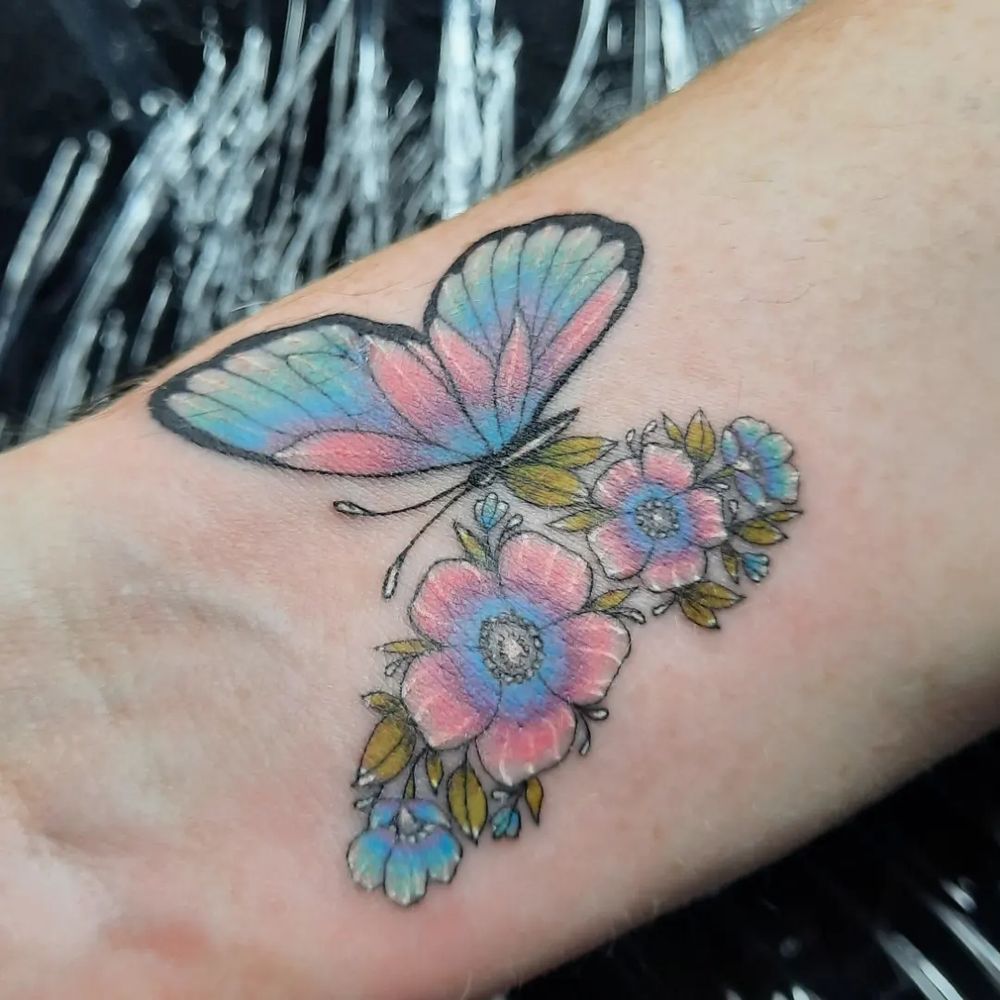 A beautiful butterfly tattoo, where half of its wings are flowers 
