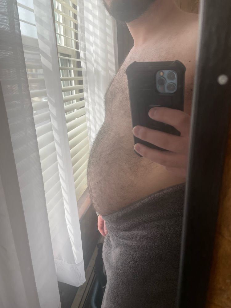 A side angle shot of myself after a shower, the towel is currently up around my belly and waist