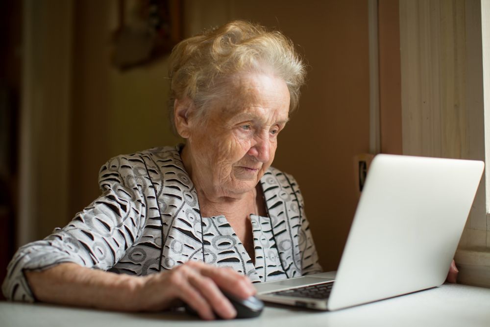 Photo of an older woman using a laptop.
