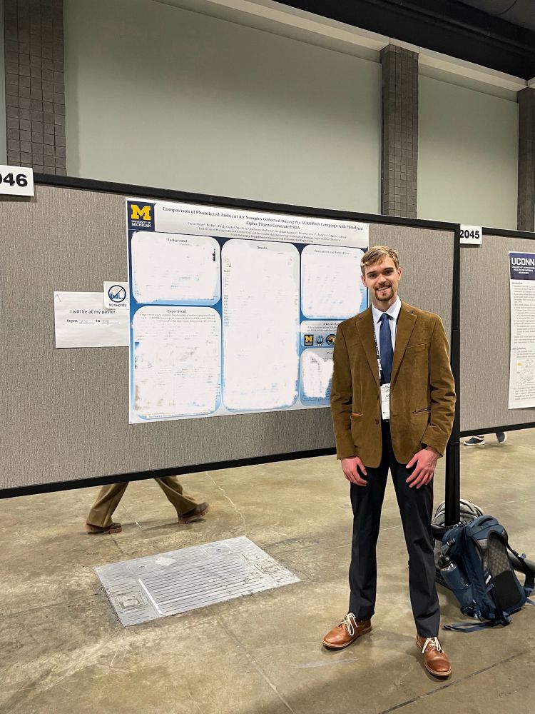 Corin standing in front of his AGU poster.