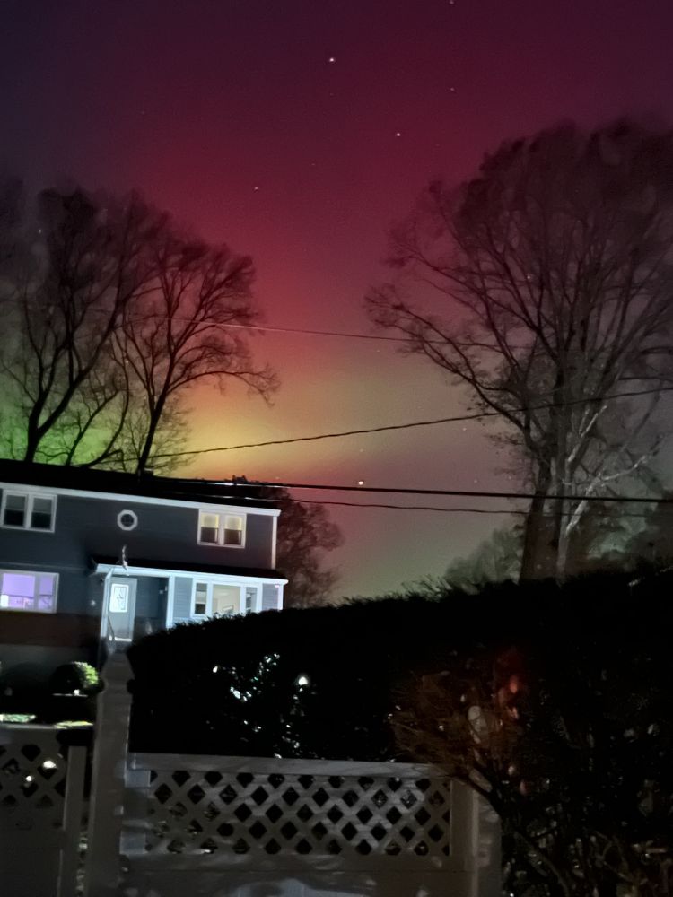 Northern lights over houses.